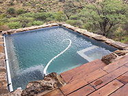 house pool with stone wall & prosopis wooden deck