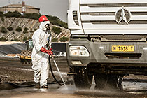 arsenic waste site | worker water cleaning truck