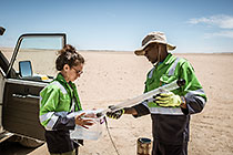 environmental monitoring & field assistants taking borehole water sample