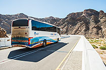 staff bus driving on bridge