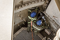workers tiding nuts on mill