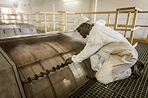 worker checking screens in screen building