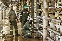 worker checking RO membrane units in reverse osmosis building