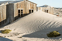 Bogenfels ghost town - sand covering old wooden house