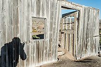 Bogenfels ghost town - photographer silhouette on old wooden house