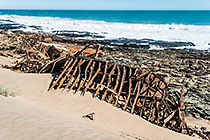 shipwreck of barge 77 on rocky shore