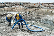 workers suctioning diamondiferous gravel