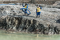 workers suctioning diamondiferous gravel