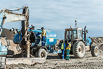 tractor with transvac unit emptying diamondiferous material into processing plant inlet grid