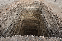 man-digged hole for diamond sampling along Orange river