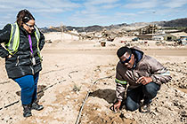 environmental officers Jefta & Denise checking irrigation lines for plant rehabilitation on  tailings with natural slope
