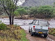 ranger in front of flowing river