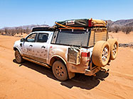 ranger coivered by red sand