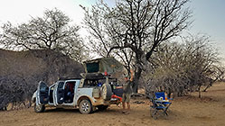 Paul near ranger at wild campsite in riverbed