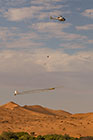 helicopter flying with SkyTEM rig over sand dunes