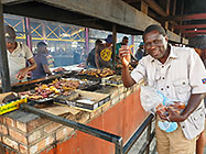 Elias eating kapana at market