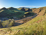 kuiseb river flowing through hills covered with grass