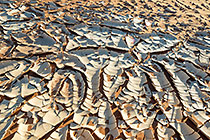 cracked mud covered with sand