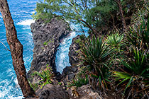waves breaking under natural rock arch