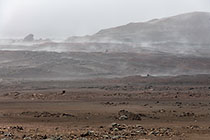 rock formations on lava field under rain & clouds