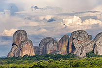 huge granite boulders between green vegetation