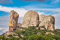 huge granite boulders between green vegetation