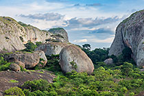 huge granite boulders between green vegetation