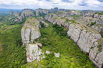 huge granite boulders between green vegetation