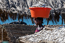 woman near fish drying racks