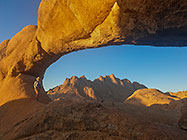Lisa under natural arch & Spitzkoppe mountain