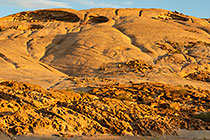 rock formation on granite monolith mountain at sunset