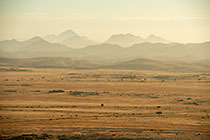 plain & mountains under mist at sunrise