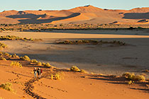 Lisa, Don & Sandy climbing sand dunes at sunrise