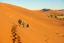 Lisa, Don & Sandy climbing sand dunes at sunrise
