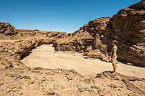 James looking at sandy riverbed in canyon