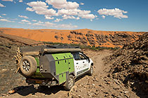 ranger camper driving down rocky steep track into canyon