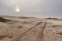 track on salt pan under mist at sunrise 