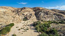 ranger camper driving on sandy track in riverbed