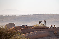 people jumping on rock