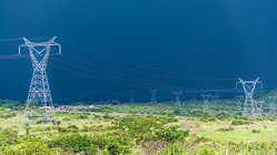 electric line pilones under stormy sky