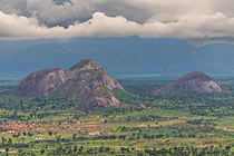green plain & mountains under stormy clouds