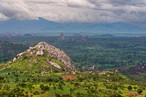 green plain & mountains under stormy clouds