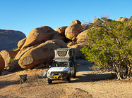ranger camper at wildcamp between granite boulders