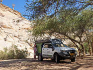 Lisa resting along ranger camper at picnic spot under ana tree