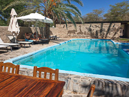 James & Naomi relaxing near swimming pool in garden