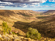 valley & plateau at sunset under clouds