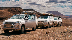 camping cars on gravel road under clouds