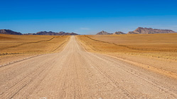 straight gravel road in arid landscape