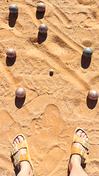 Marie's feet next to petanque balls