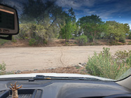 motorcycle track crossing dry riverbed